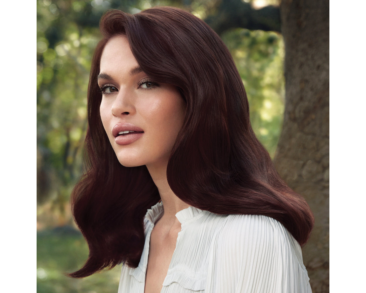 PAUL MITCHELL Tea Tree Hair and Scalp Treatment. Female model with styled hair.